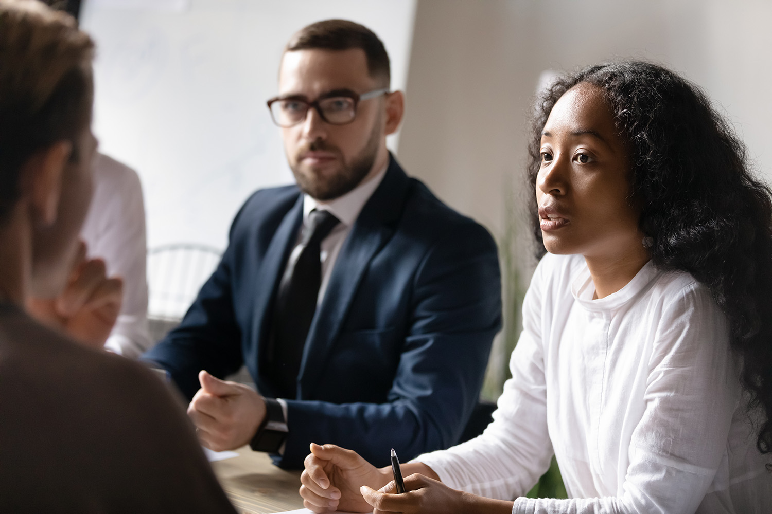 shutterstock_1708060480 couple talking to a woman at a desk